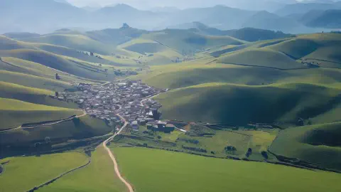Mountains along the Camino De Santiago Aerial Photo Of Mountains From The Camino De Santiago Sunny Day Green Fields Pathway Villages