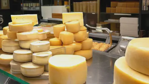 A counter top with queso de Arzúa on display A counter top at a spanish cheese shop with queso de Arzúa on display