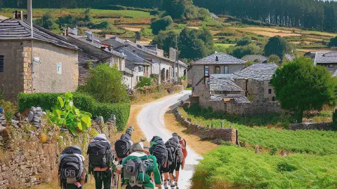 Pilgrims approaching the village of Gonzar, Galicia, Spain, along the Camino Francés
