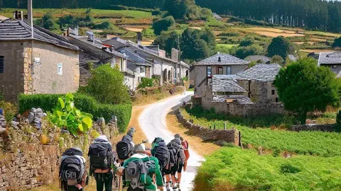 Pilgrims approaching the village of Gonzar, Galicia, Spain, along the Camino Francés