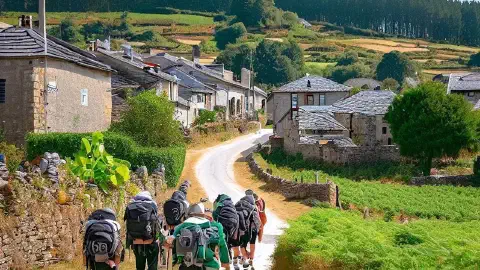 Pilgrims approaching the village of Gonzar, Galicia, Spain, along the Camino Francés
