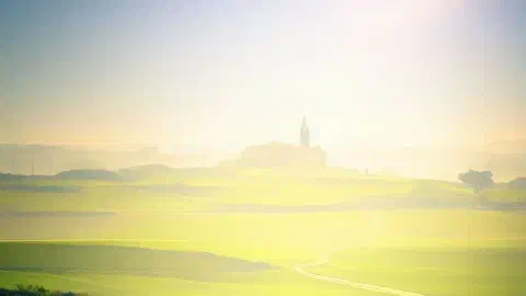 Camino Francés trail with San Juan de Ortega, northern spain, in the distance, photographic, sunshine