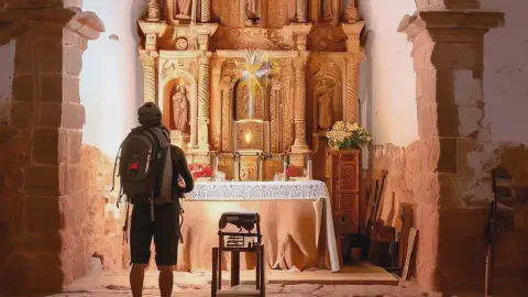 A Pilgrim Standing Near To The Altar Of The Iglesia De San Roma Hornillos Del Camino Spain A Pilgrim standing near to the altar of the Iglesia de San Román, Hornillos del Camino, Spain