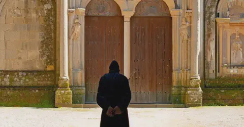 A Monk facing the doors of the Monasterio de Santa Maria de Sobrado dos Monxes A Monk facing the doors of the Monasterio de Santa Maria de Sobrado dos Monxes, Galicia, Spain
