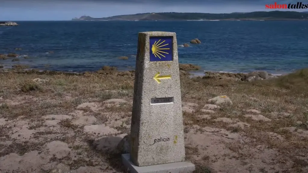 Camino De Santiago Waymarker with Finisterre In the Distance Camino De Santiago Waymarker Finisterre In Distance