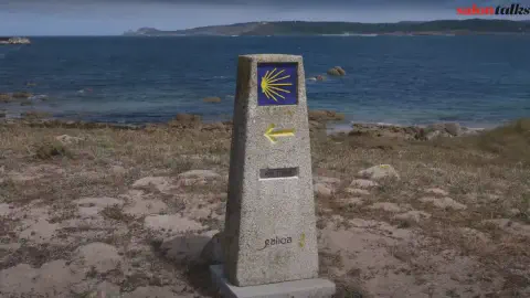 Camino De Santiago Waymarker with Finisterre In the Distance Camino De Santiago Waymarker Finisterre In Distance