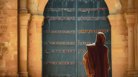 A monk standing in front of a door at Monasterio De Santa Maria La Real De Irache Estella Spain
