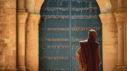 A monk standing in front of a door at Monasterio De Santa Maria La Real De Irache Estella Spain
