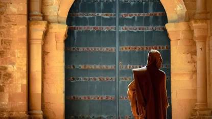 A monk standing in front of a door at Monasterio De Santa Maria La Real De Irache Estella Spain