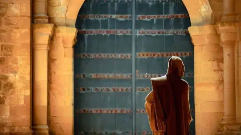 A monk standing in front of a door at Monasterio De Santa Maria La Real De Irache Estella Spain