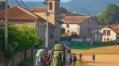 Pilgrims approaching the village of Palas De Rei, Spain, along the Camino Frances