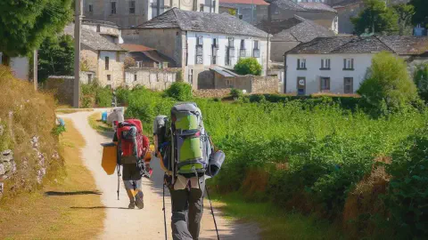 Hikers Approach Hospital Da Condesa Hikers Approaching The town of Hospital Da Condesa on the Camino Francés, part of the Camino de Santiago, Spain