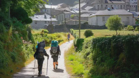Pilgrims arrive at Calvor along the Camino Francés Modern Pilgrims arriving on foot at Calvor along the Camino Francés, The French Way of the Camino de Santiago