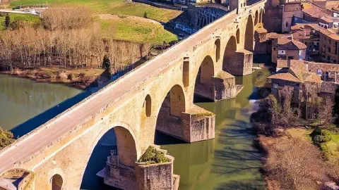 Puente de la Reina, medieval bridge, romanesque, in Spain, in the distance, ariel view, on a sunny day